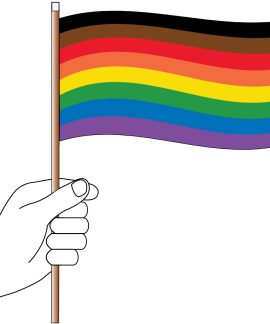 Hand holding inclusive pride flag