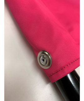 Close-up of pink fabric with metal snap button