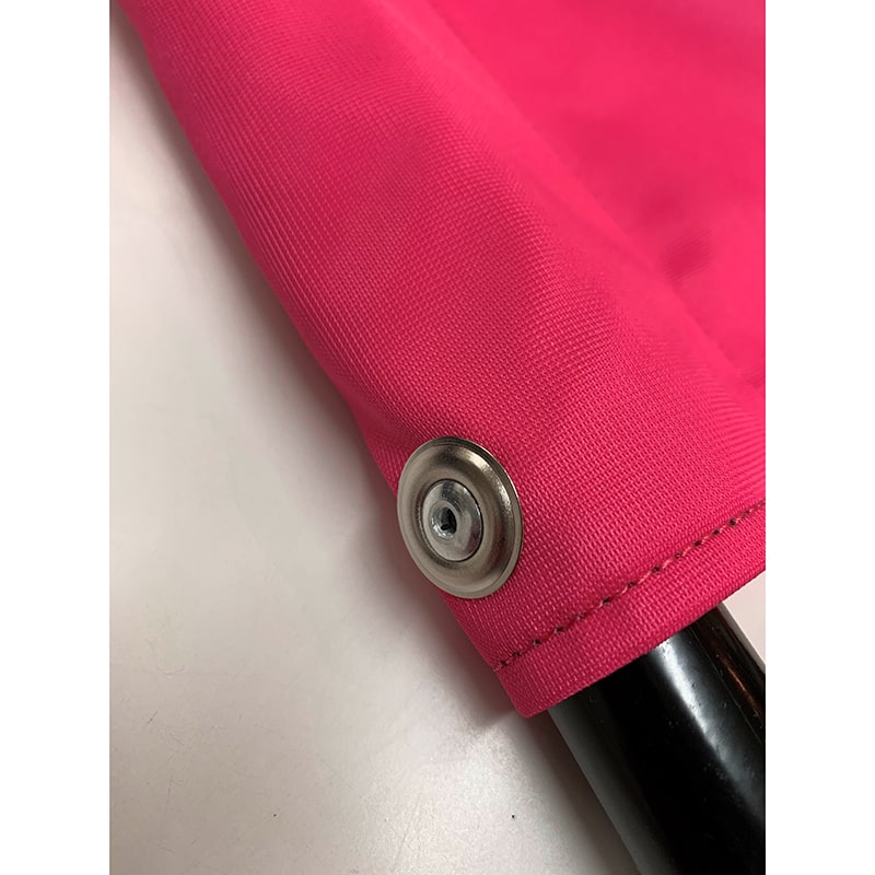 Close-up of pink fabric with metal snap button