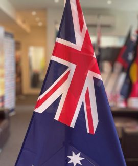 Australian flag displayed indoors on a stand