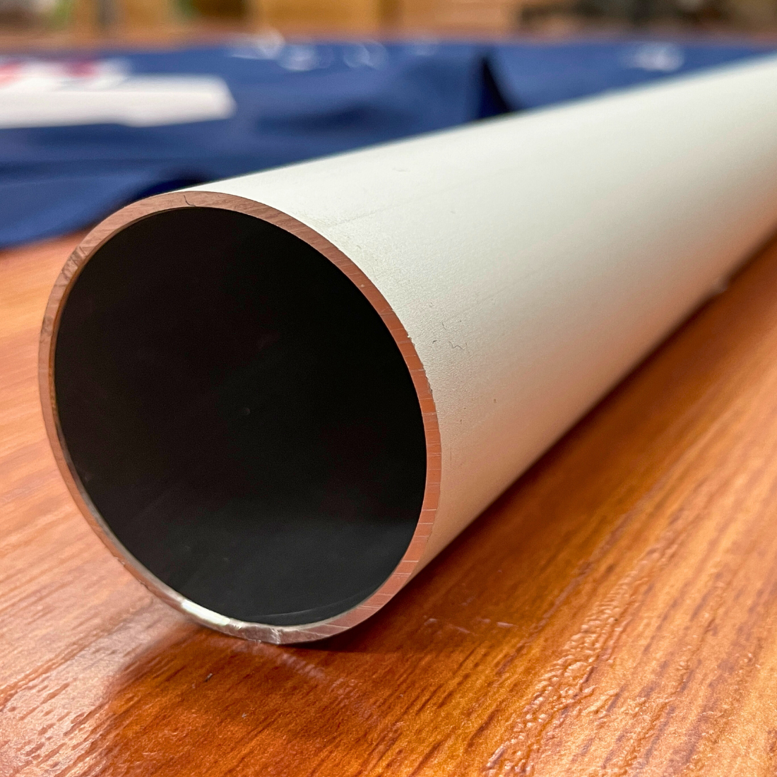 Close-up of a metal pipe on wood surface