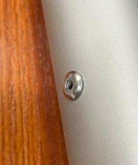 Close-up of screw on metallic surface
