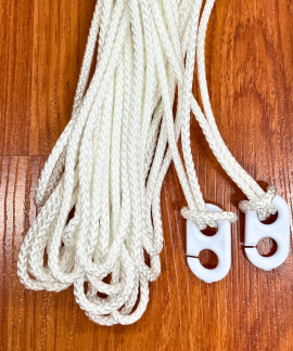 White braided cords with plastic clips on wood