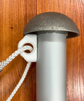 Flagpole rope cleat on wooden background