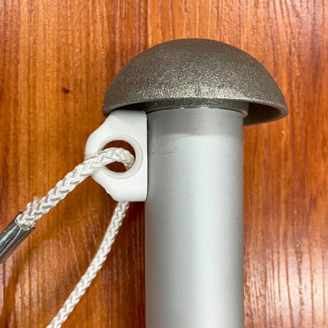 Flagpole rope cleat on wooden background
