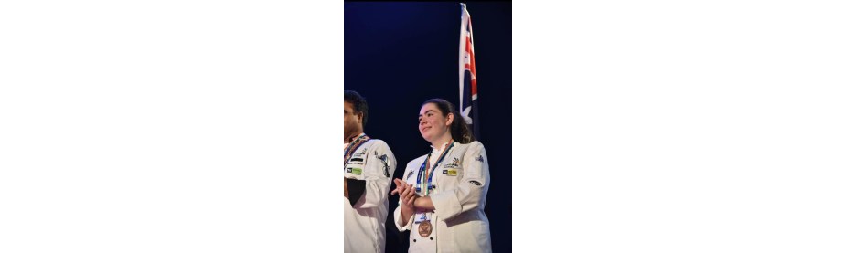 Chef holding flag on stage during competition