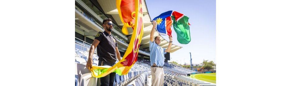 Fans waving colorful flags in stadium stands