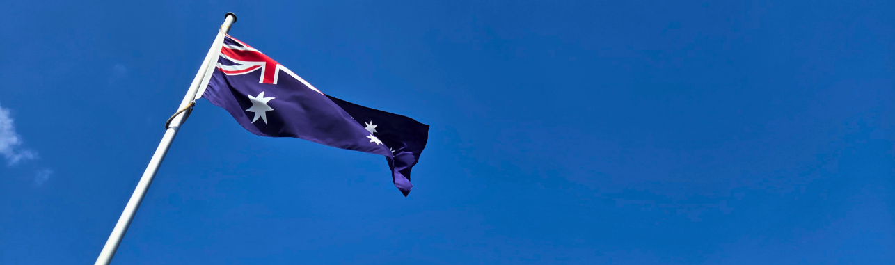 Australian flag waving against clear blue sky